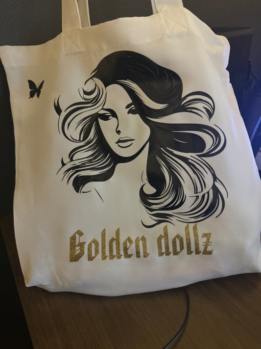 Golden dollz tote bags